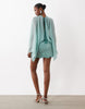 Caped Open Back Mini Dress With Embellished Skirt In Turquoise